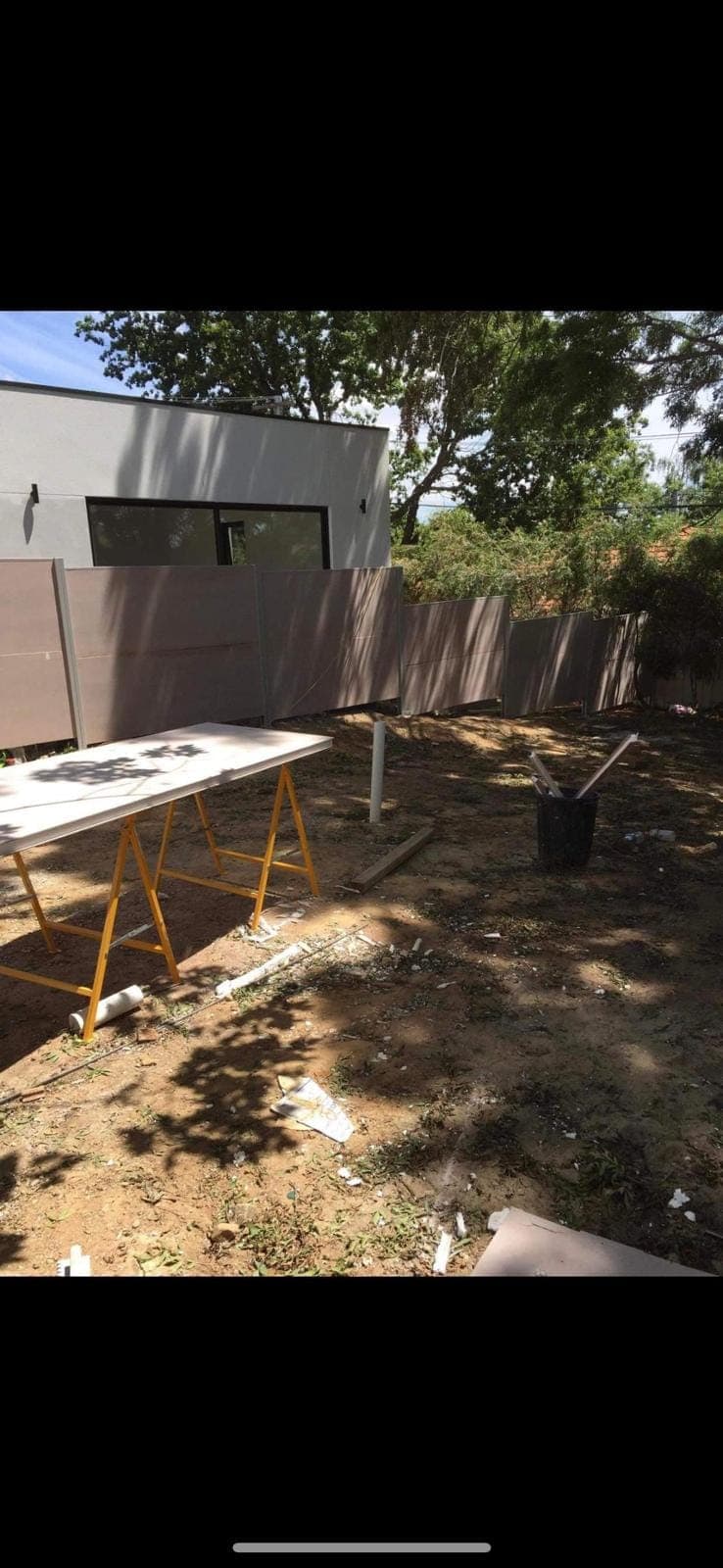 Renovation photo: outdoor yard with fence and workbench