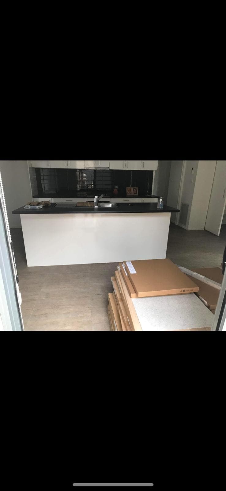 Renovation photo: kitchen with dark island benchtop