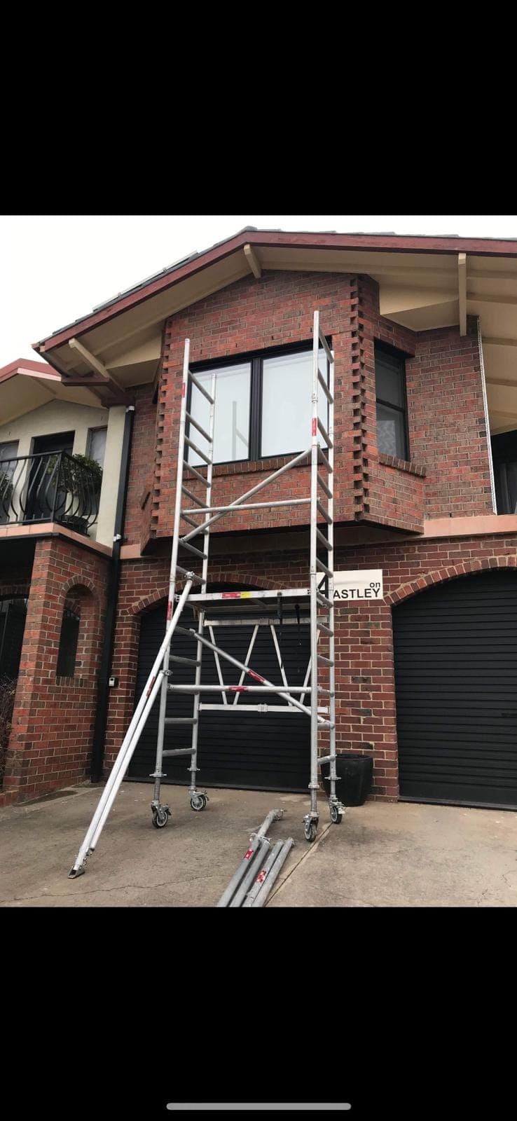 Renovation photo: brick house exterior with scaffolding erected