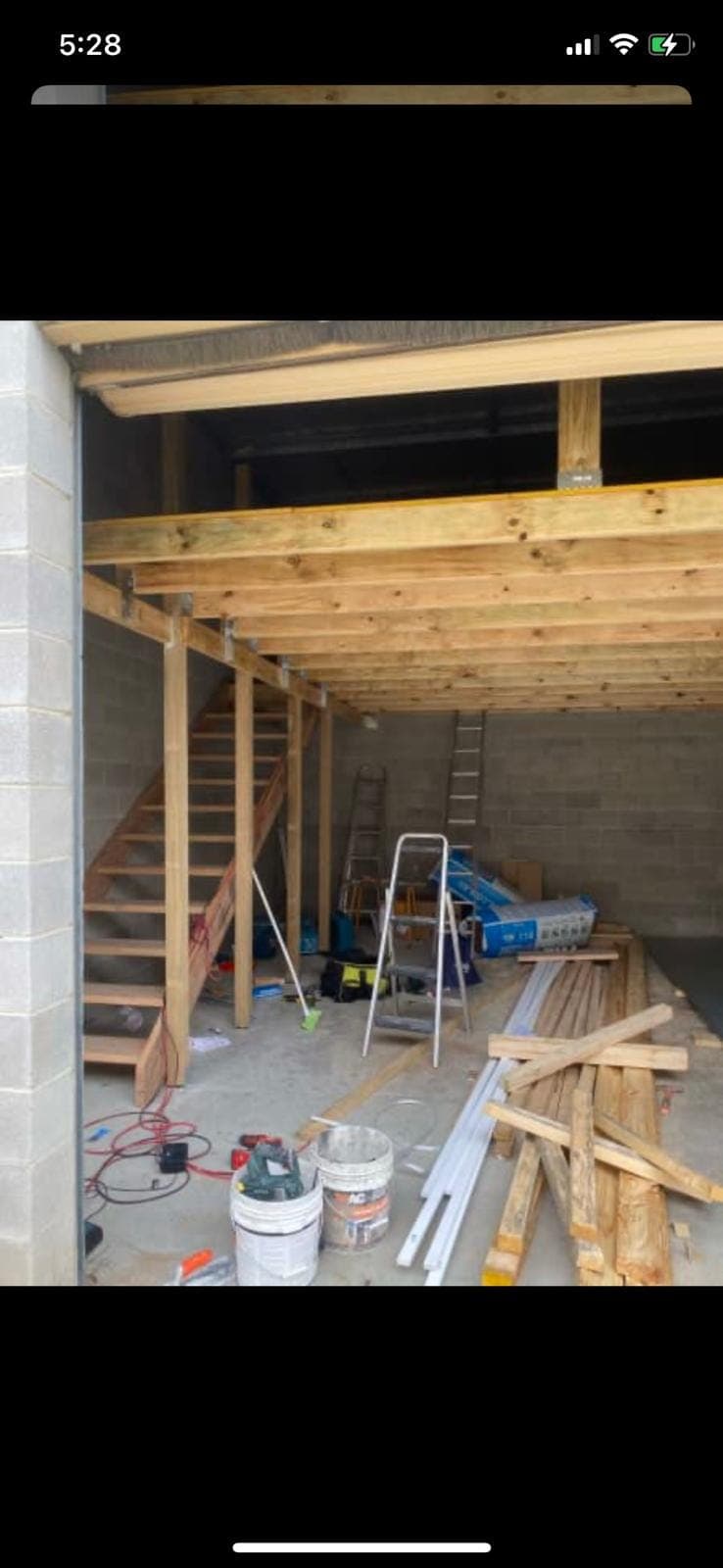 Renovation photo: garage interior with timber framing and ladder