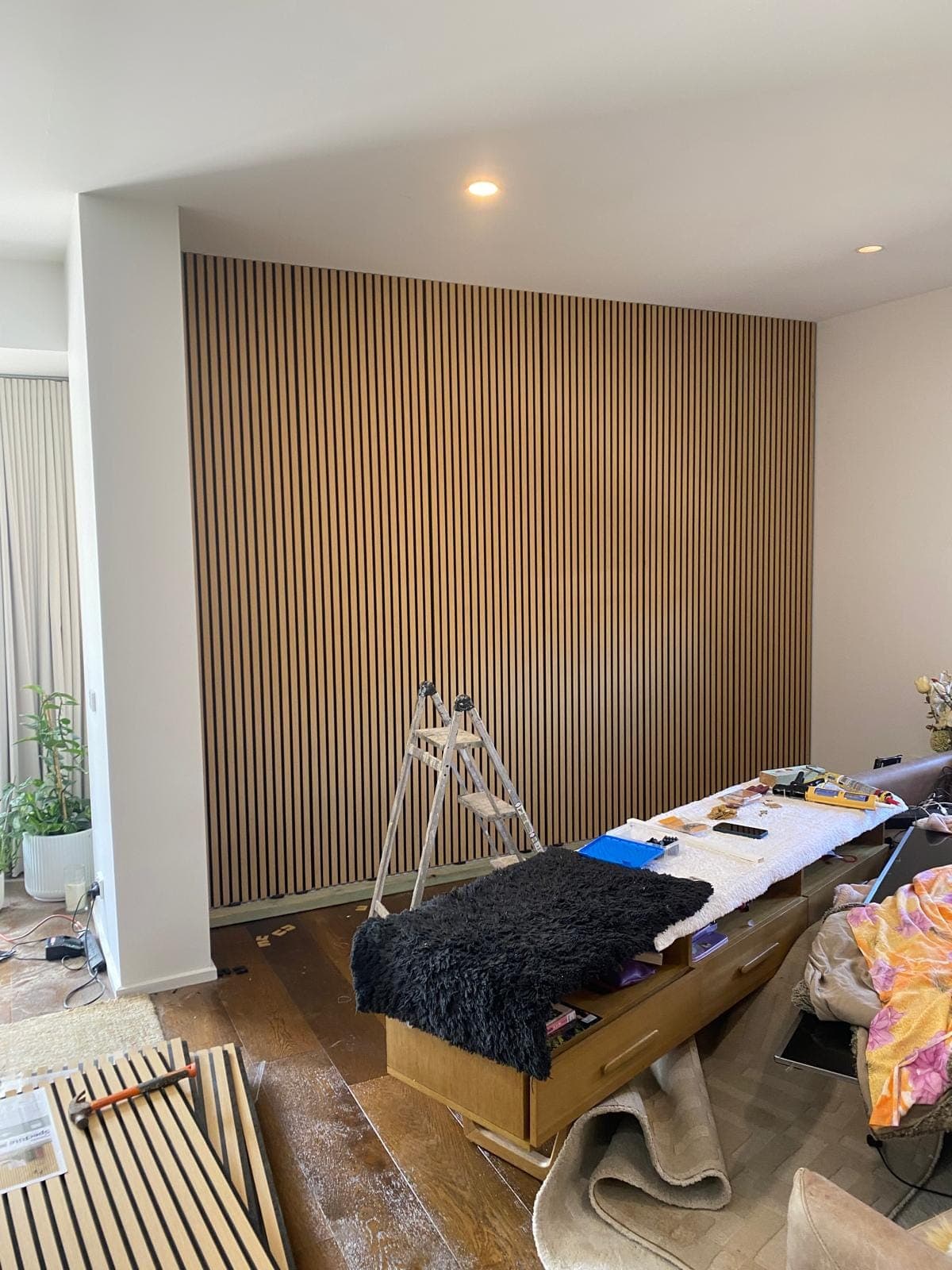 Renovation photo: interior with timber slat feature wall