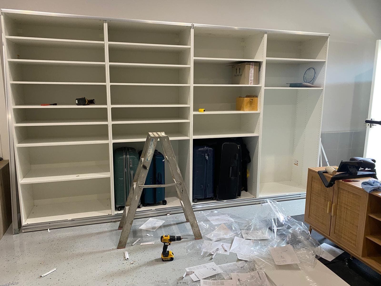 Renovation photo: white built in shelving unit being assembled