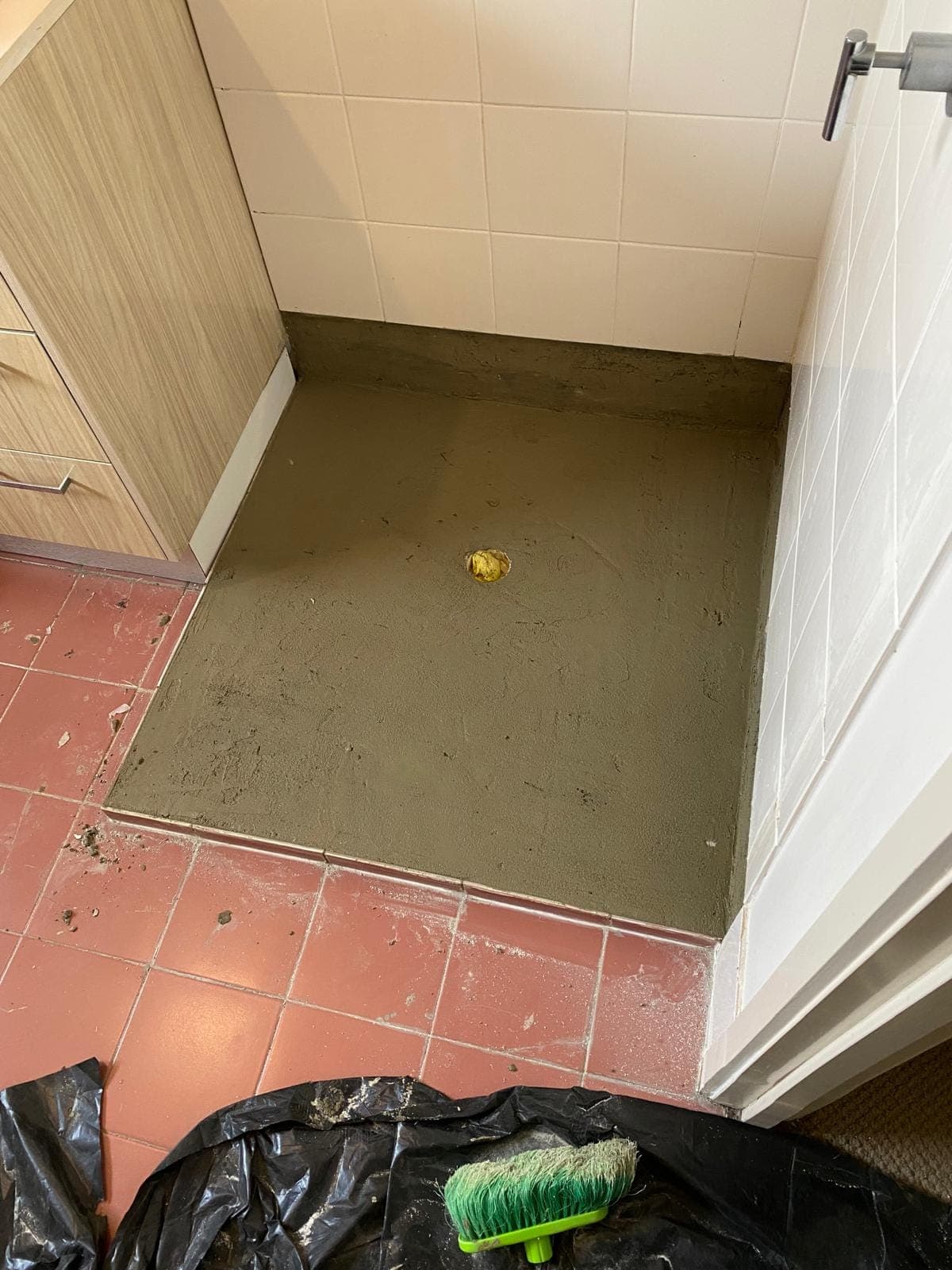Renovation photo: shower base with grey waterproofing membrane