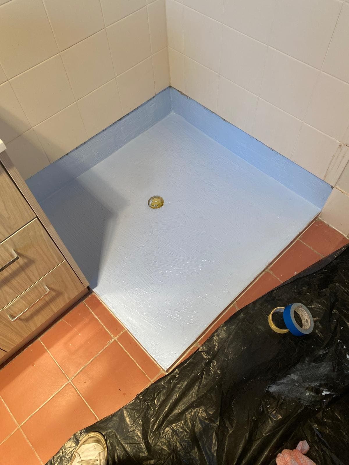 Renovation photo: shower base with grey waterproofing membrane