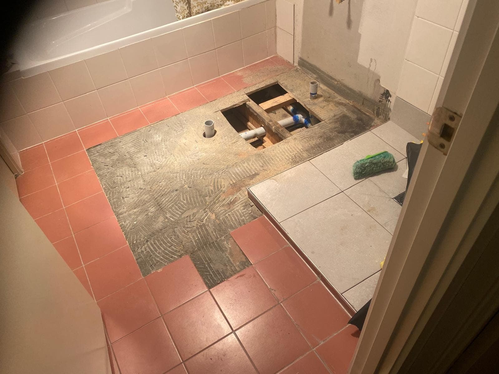 Renovation photo: bathroom floor being retiled with terracotta tiles