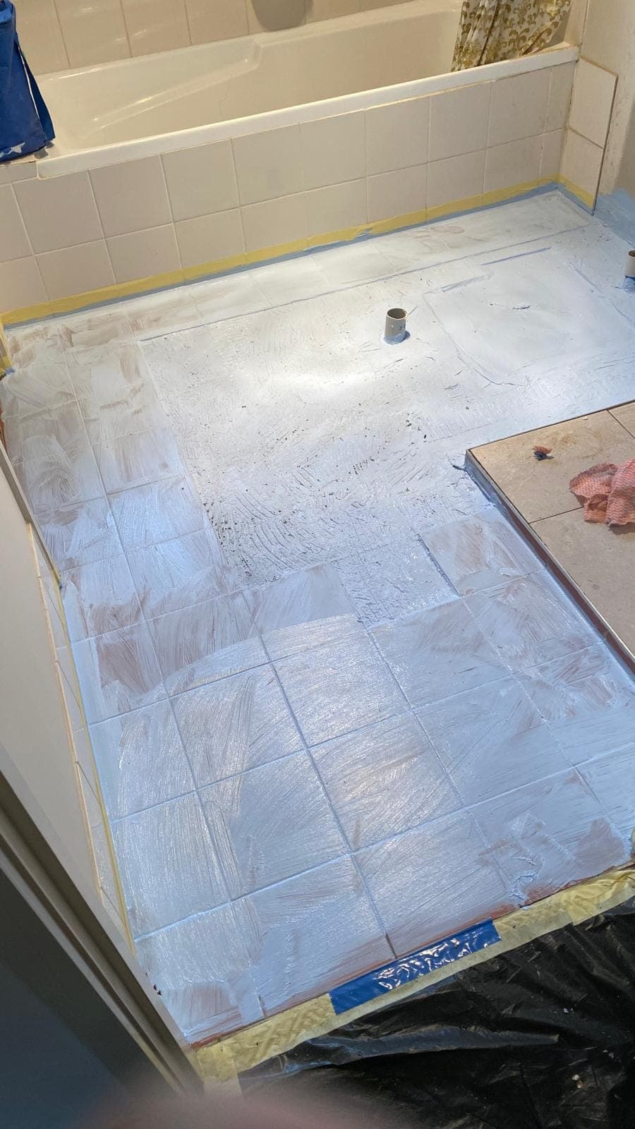 Renovation photo: bathroom floor being retiled with terracotta tiles
