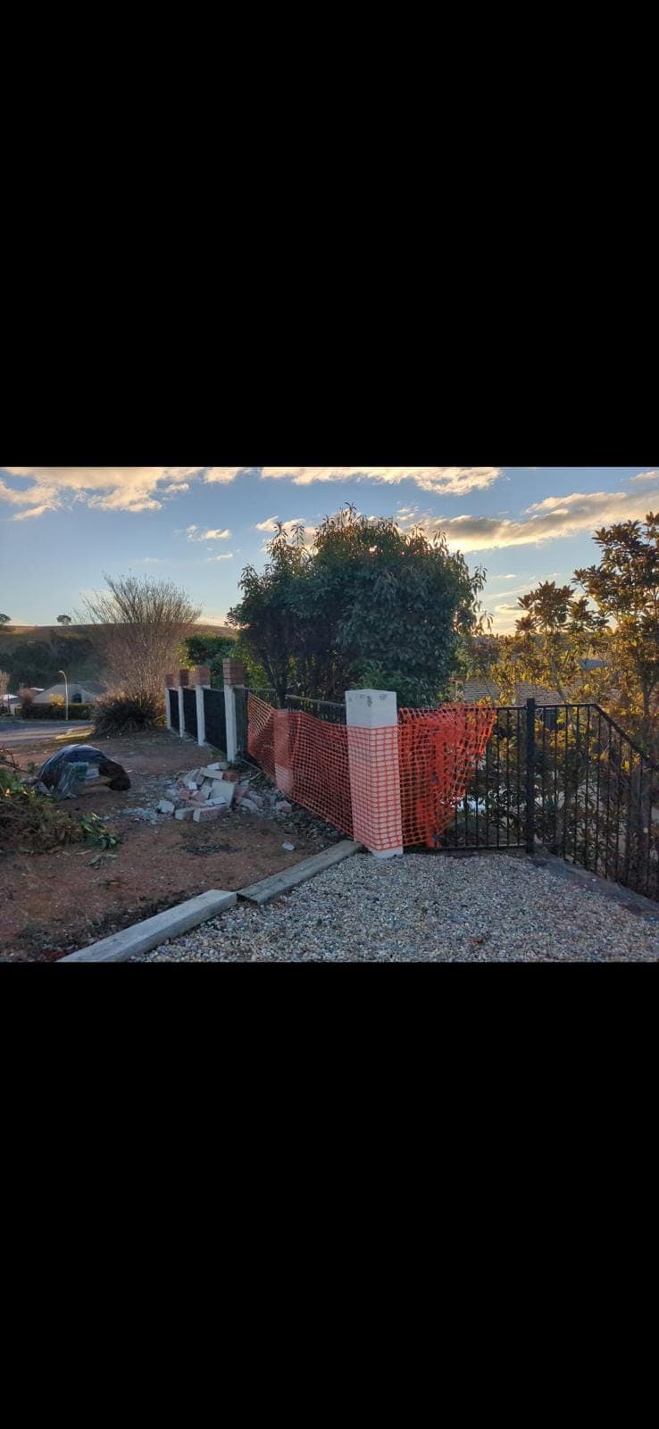 Renovation photo: outdoor fence with brick pillars under construction
